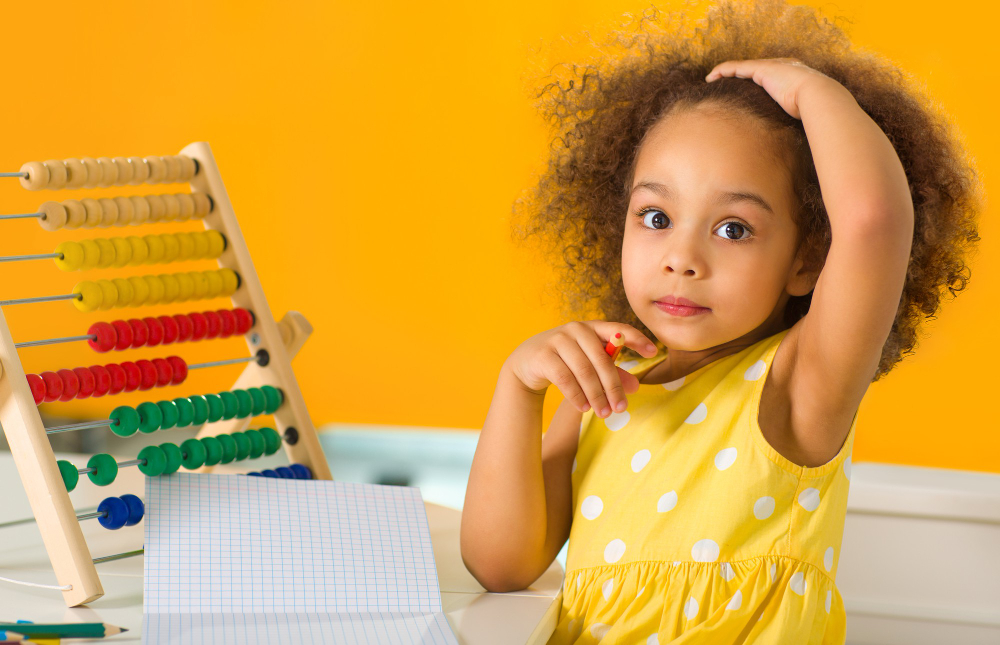 black-girl-is-puzzled-by-an-example-of-arithmetic-that-she-must-count-on-the-abacus 1.jpg